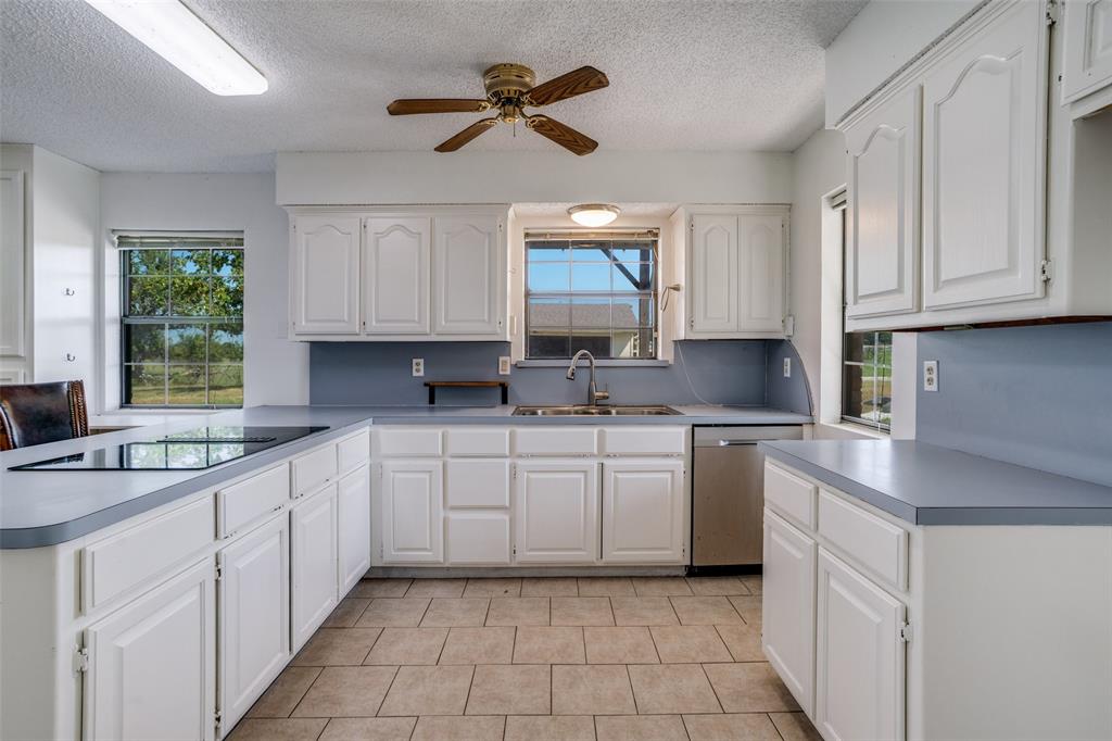 7397 Fm 1377 Blue Ridge, TX 75424 - Photo 11 of 27 a kitchen with granite countertop white cabinets white appliances a sink and a window