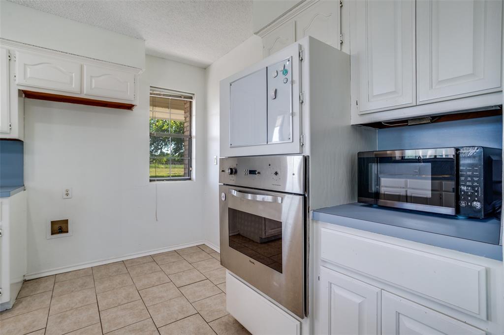 7397 Fm 1377 Blue Ridge, TX 75424 - Photo 12 of 27 a kitchen with granite countertop white cabinets stainless steel appliances and a window