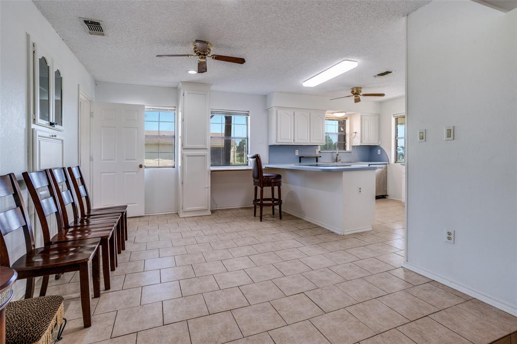 7397 Fm 1377 Blue Ridge, TX 75424 - Photo 9 of 27 a living room with a dining table chairs and a refrigerator