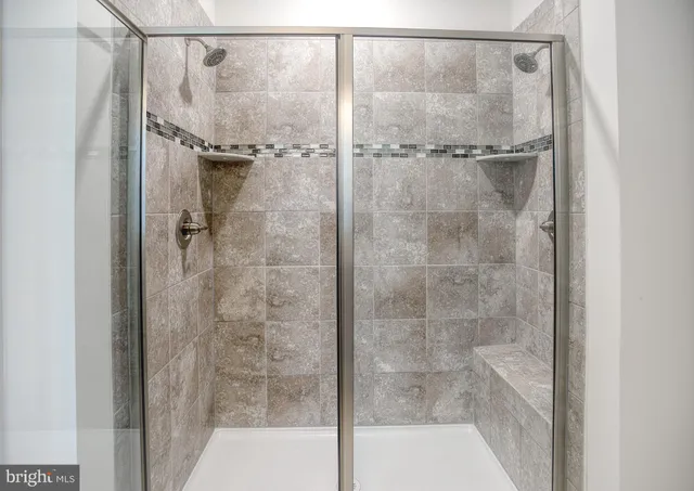 a bathroom with a glass shower door