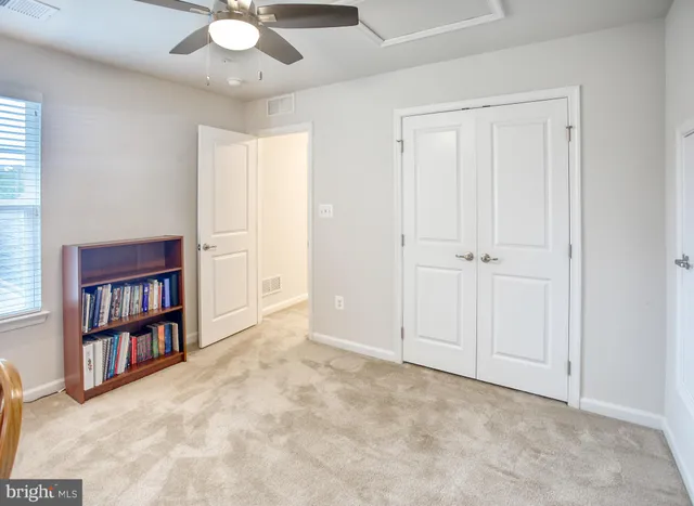 a view of an empty room with a bookshelf