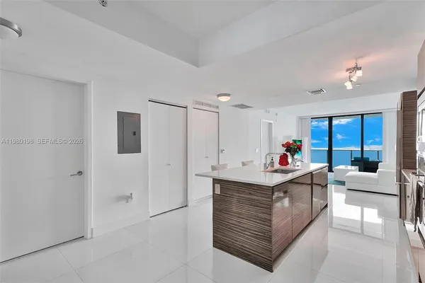 a bedroom with a large bed and a balcony view
