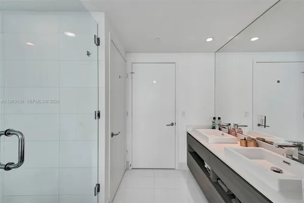 a living room with furniture a flat screen tv and floor to ceiling window