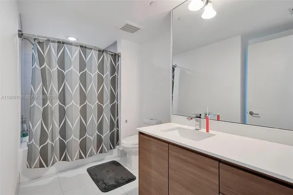 a dining hall with stainless steel appliances a dining table and chairs