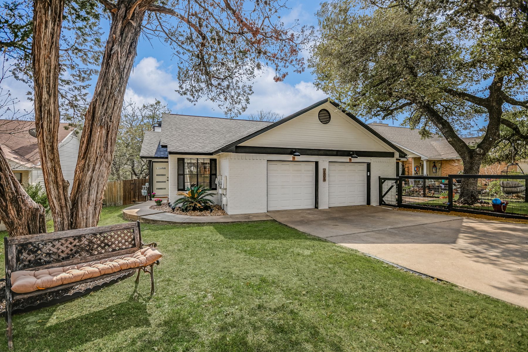 2605 Garrettson Drive, Unit A Austin, TX 78748 - Photo 1 of 21 a front view of a house with a garden and yard