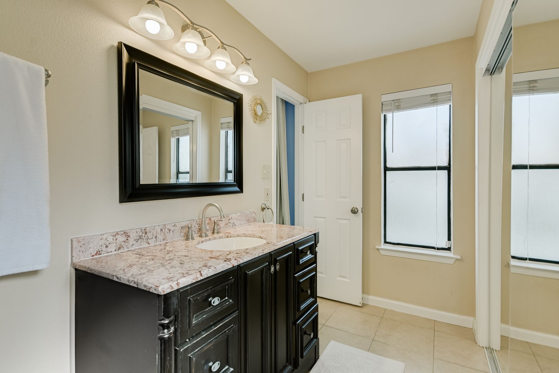 2605 Garrettson Drive, Unit A Austin, TX 78748 - Photo 13 of 21 a bathroom with a sink and a mirror