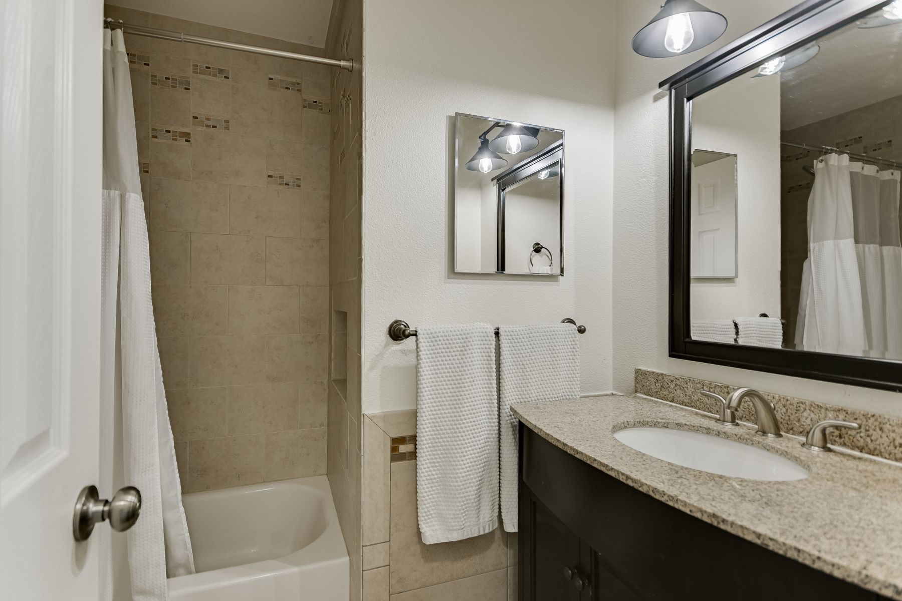2605 Garrettson Drive, Unit A Austin, TX 78748 - Photo 14 of 21 a bathroom with a granite countertop sink mirror and a bathtub