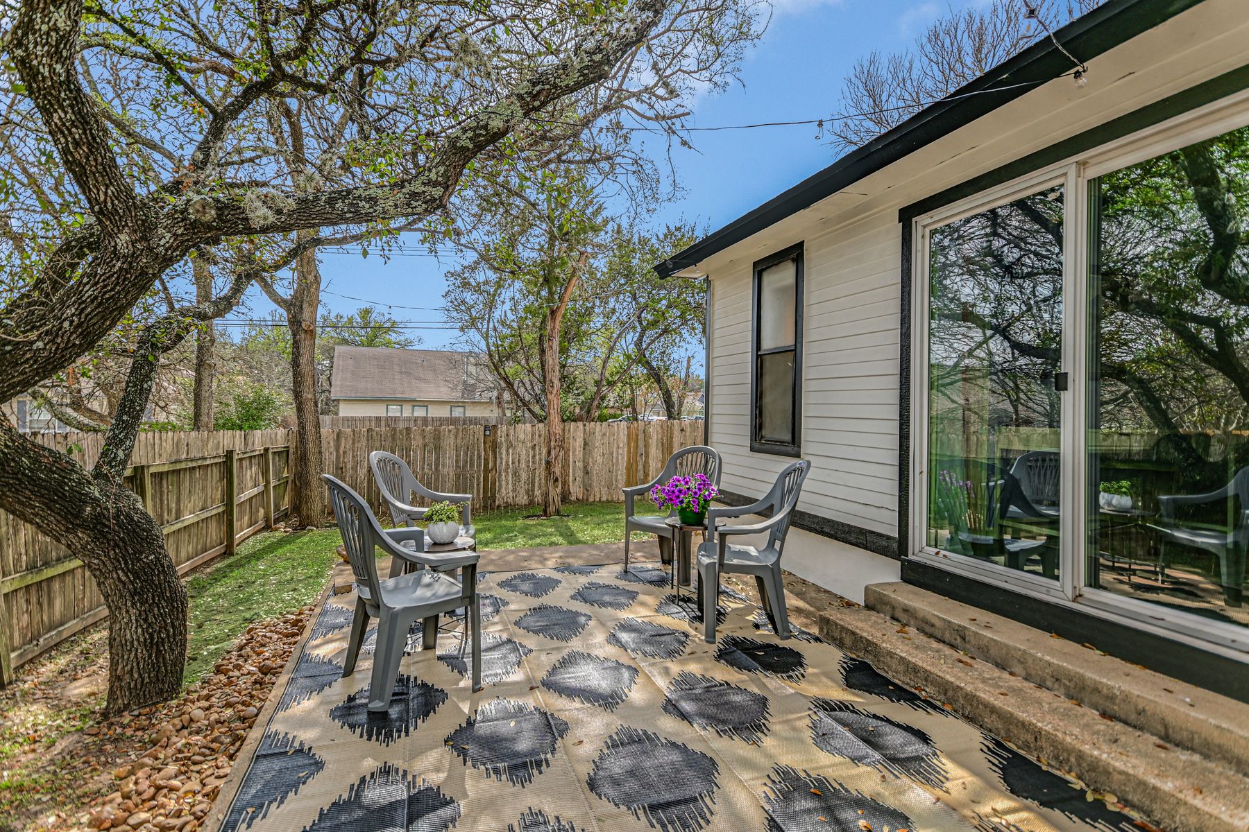 2605 Garrettson Drive, Unit A Austin, TX 78748 - Photo 18 of 21 a view of a chairs and table in backyard of the house