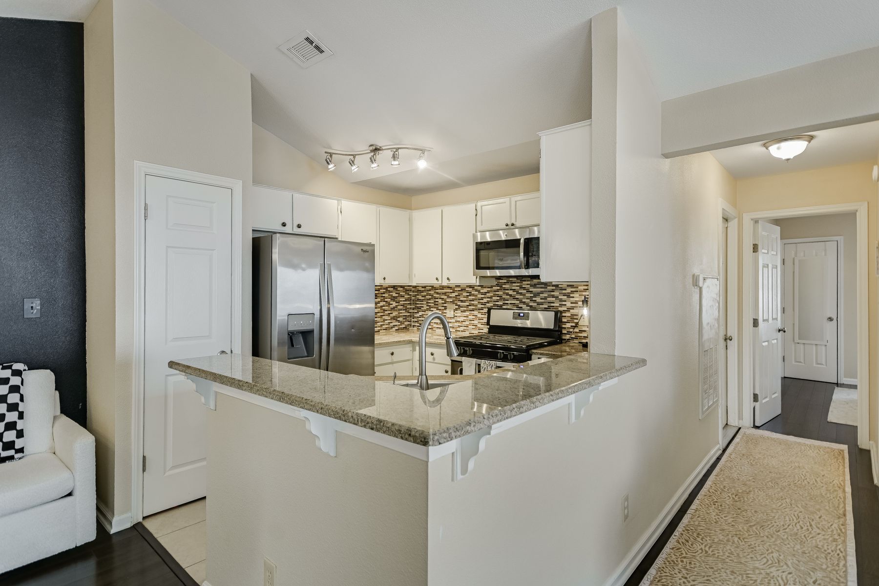 2605 Garrettson Drive, Unit A Austin, TX 78748 - Photo 7 of 21 a kitchen with stainless steel appliances granite countertop a refrigerator a stove and a sink