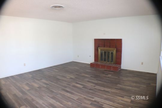 247 West Graaf Avenue Ridgecrest, CA 93555 - Photo 3 of 20 a view of empty room with wooden floor