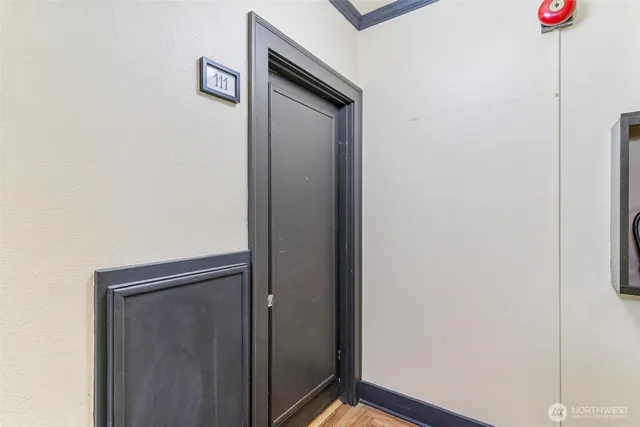 a utility room with wooden floor washer and dryer