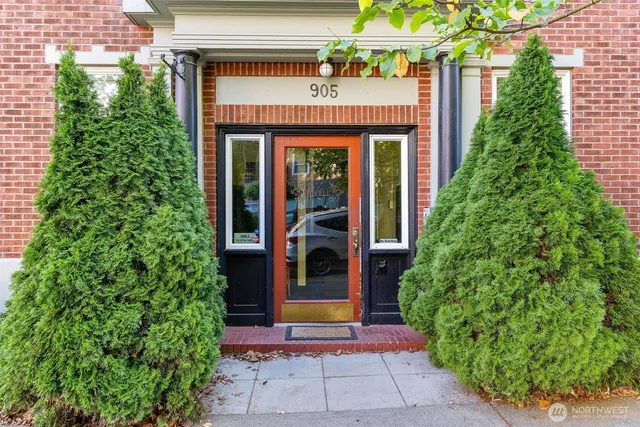 a view of a house with potted plants and a fountain