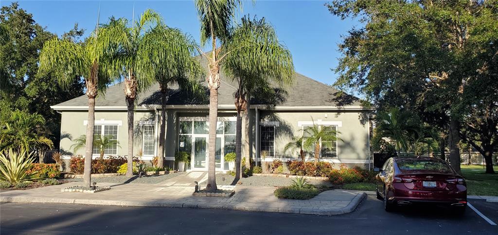 3584 Kings Road, Unit 101 Palm Harbor, FL 34685 - Photo 15 of 17 a couple of cars parked in front of a house