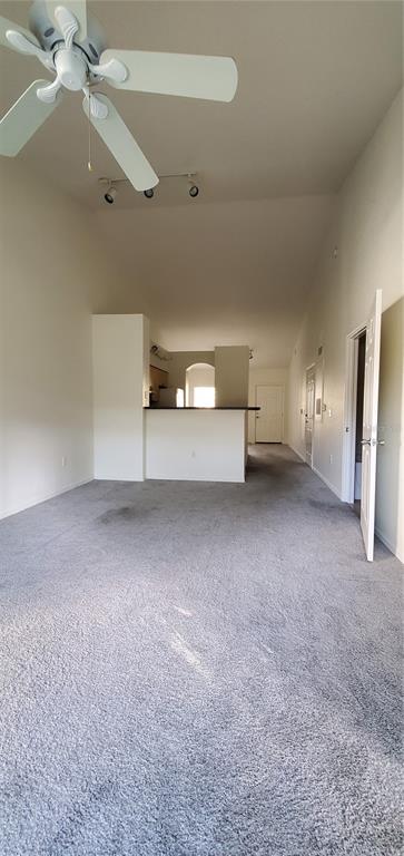 3584 Kings Road, Unit 101 Palm Harbor, FL 34685 - Photo 5 of 17 a view of a livingroom with furniture and a ceiling fan