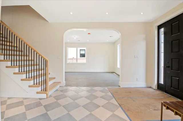 a view of a hallway with a livingroom and entryway