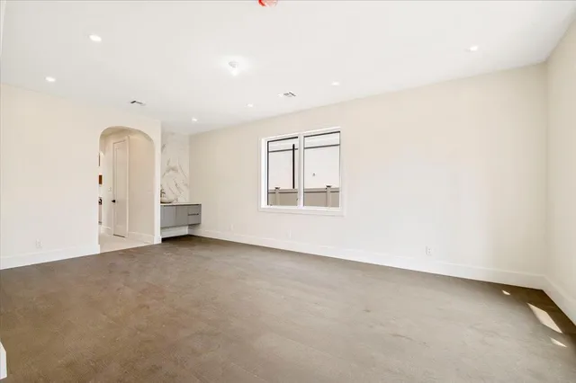 an empty room with windows and closet