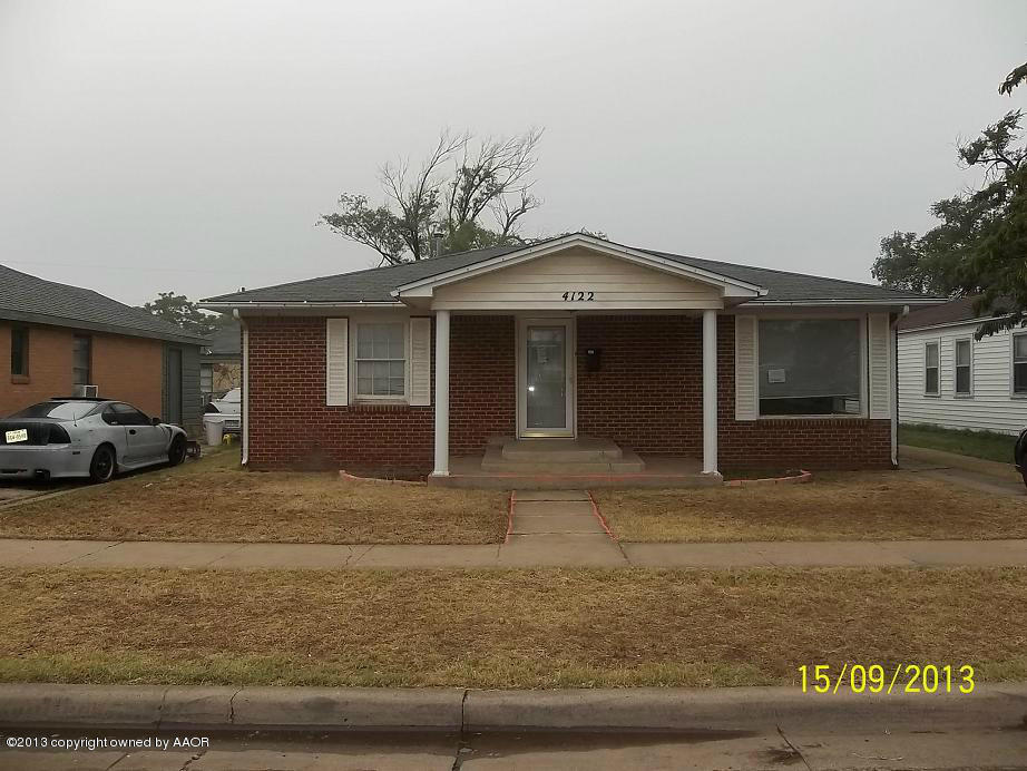 4122 South Harrison Street Amarillo, TX 79110 - Photo 1 of 10 a front view of a house with a yard and garage