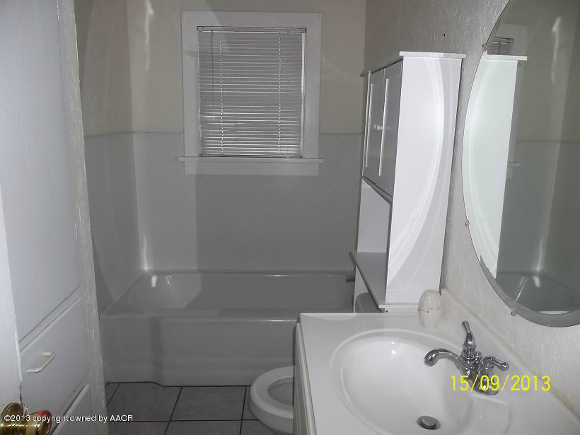 4122 South Harrison Street Amarillo, TX 79110 - Photo 8 of 10 a bathroom with a sink and toilet