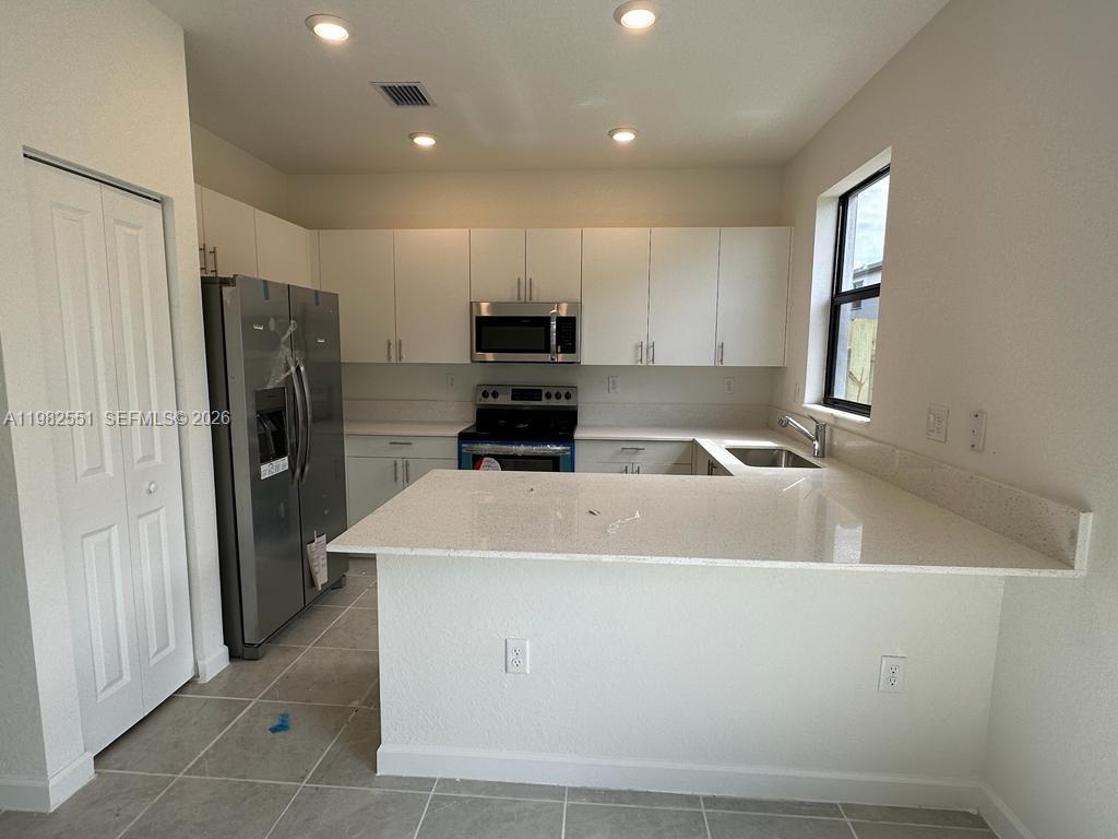 13262 Southwest 285th Street Homestead, FL 33033 - Photo 3 of 16 a close view of a refrigerator a sink and dishwasher