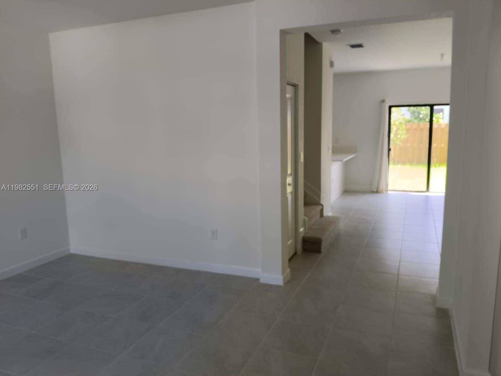 13262 Southwest 285th Street Homestead, FL 33033 - Photo 6 of 16 a view of a room with wooden floor and a hallway