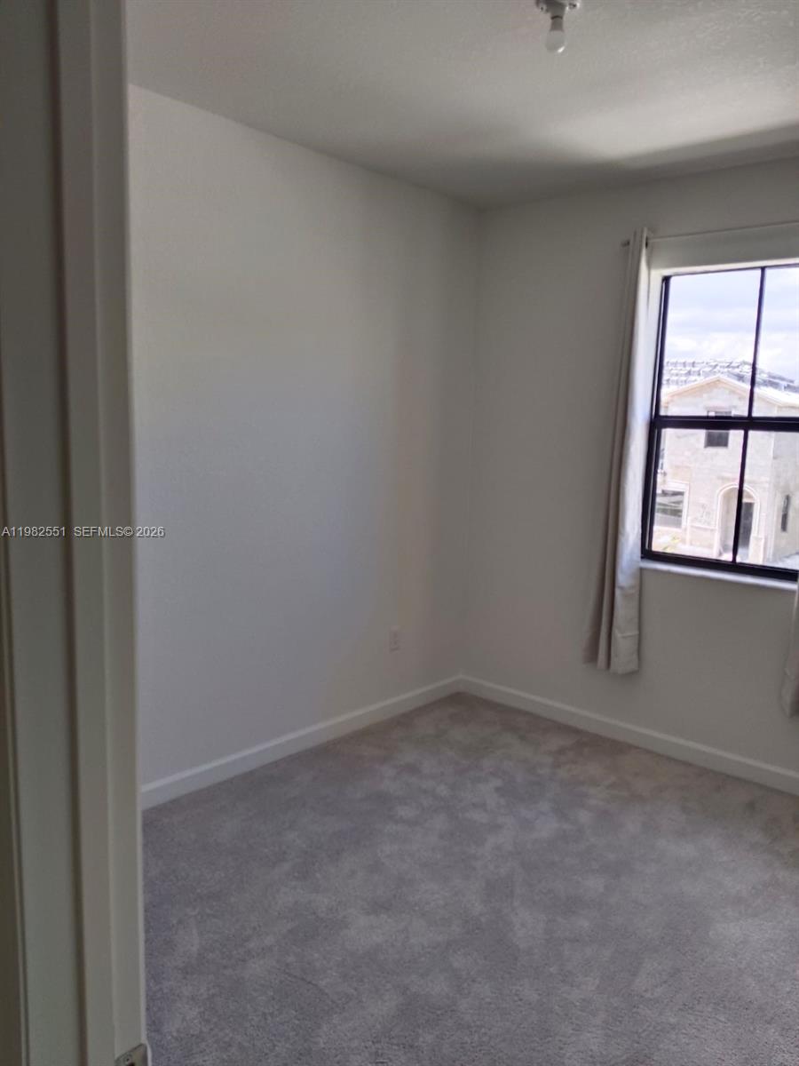 13262 Southwest 285th Street Homestead, FL 33033 - Photo 10 of 16 an empty room with windows