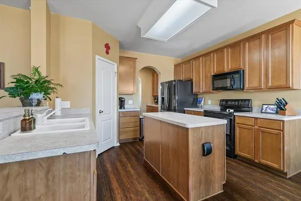 a kitchen with a sink stove and cabinets