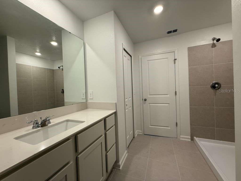 2728 Lookout Rdg Road Haines City, FL 33844 - Photo 12 of 21 a bathroom with a sink double vanity granite tub shower and a mirror