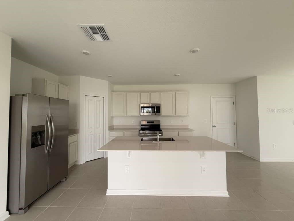 2728 Lookout Rdg Road Haines City, FL 33844 - Photo 8 of 21 a kitchen with stainless steel appliances a refrigerator a stove a sink and dishwasher