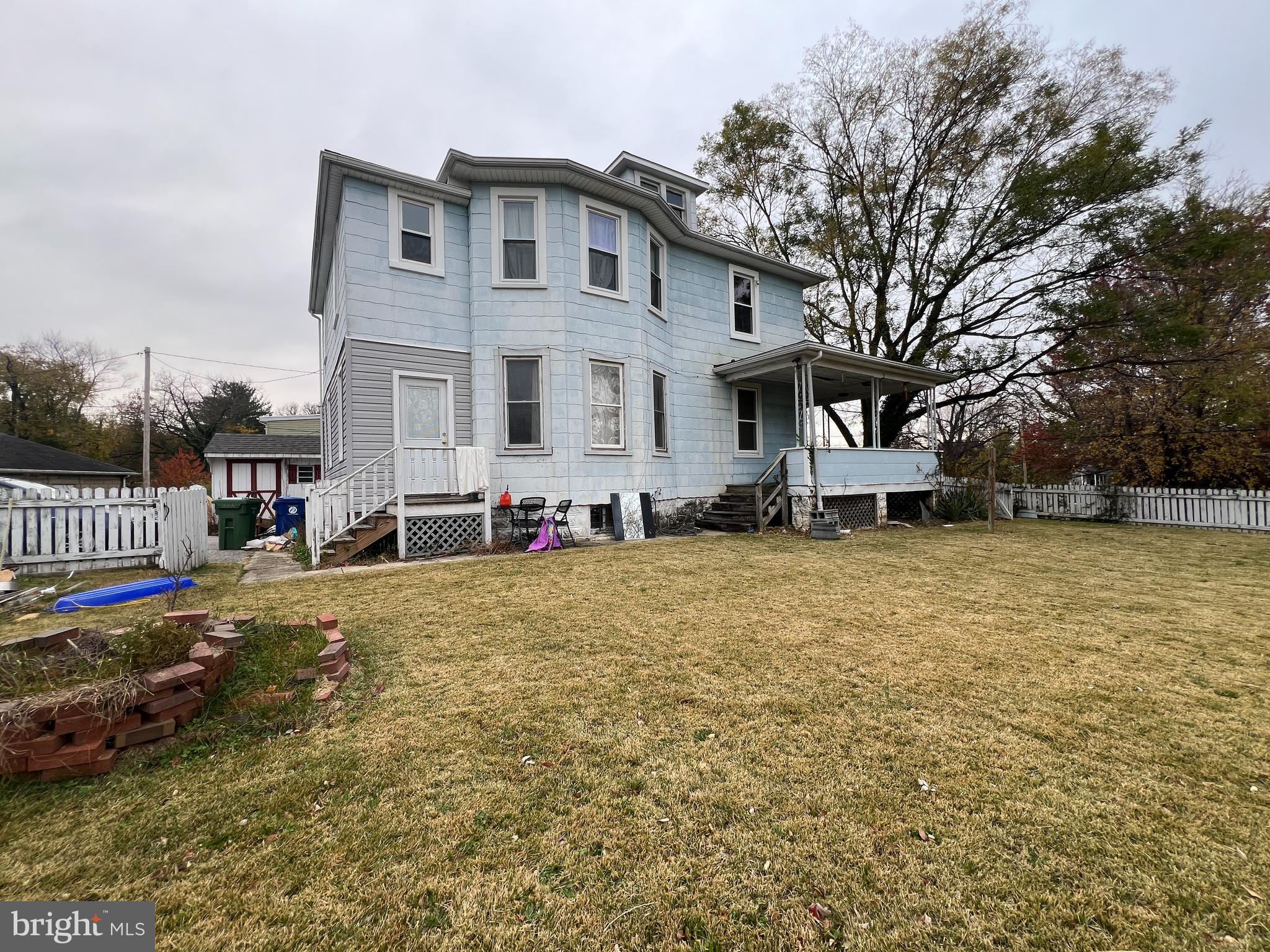 5001 Overton Street Baltimore, MD 21229 - Photo 11 of 21 a front view of house with yard and trees around