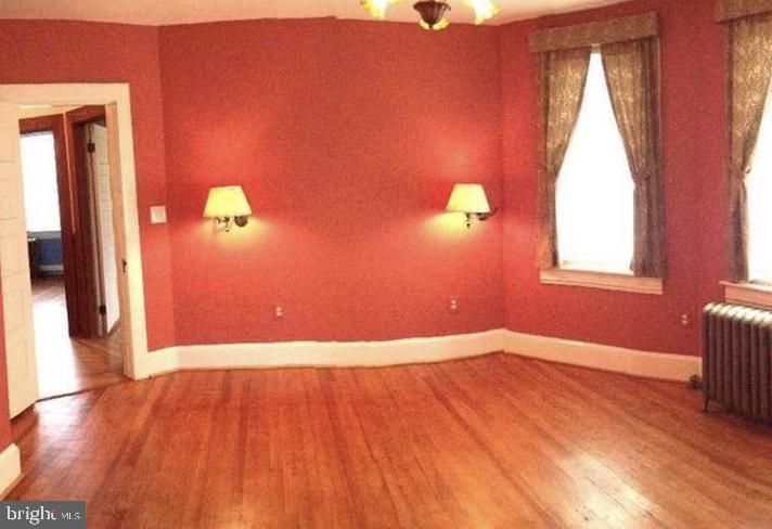 5001 Overton Street Baltimore, MD 21229 - Photo 16 of 21 a view of empty room with wooden floor and fan