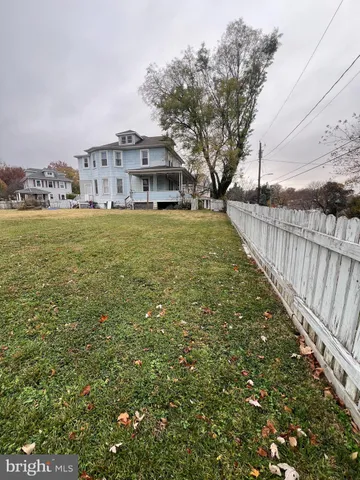 a front view of house with yard and trees around