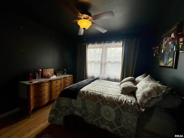 a bed sitting in a bedroom next to a window