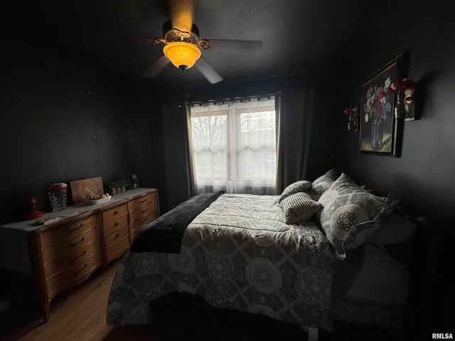 a bed sitting in a bedroom next to a window