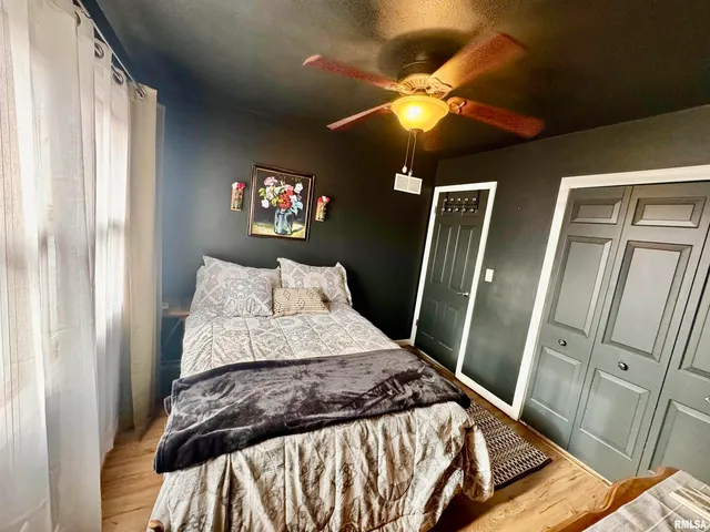 a bedroom with a bed and a mirror