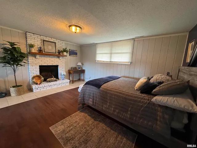 a bed room with a bed and a fireplace