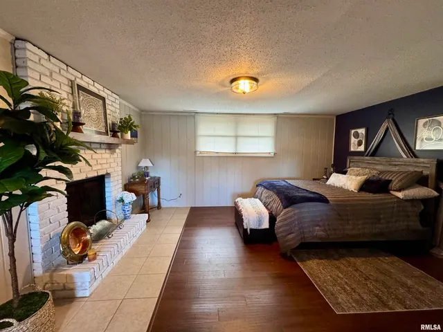 a bedroom with a bed couch and a window