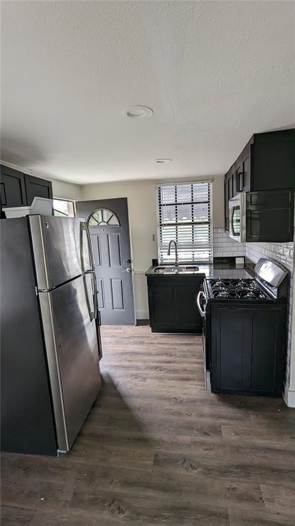 1020 South Rome Avenue, Unit 1/2 Tampa, FL 33606 - Photo 4 of 8 a kitchen with stainless steel appliances granite countertop a refrigerator a stove a sink and a microwave
