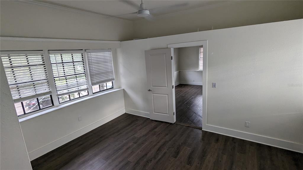 1020 South Rome Avenue, Unit 1/2 Tampa, FL 33606 - Photo 6 of 8 an empty room with wooden floor and windows