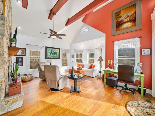 a living room with furniture a fireplace and a flat screen tv