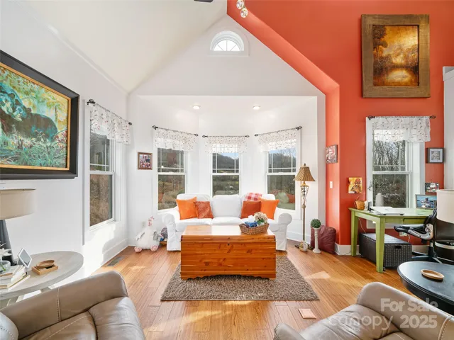a living room with furniture and large windows