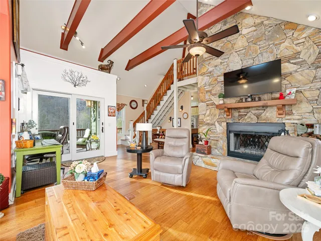 a living room with furniture a flat screen tv and a fireplace