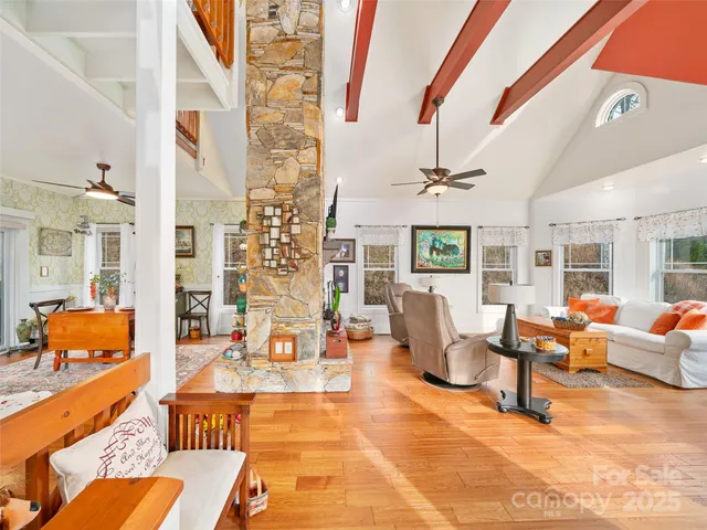 a living room with furniture and floor to ceiling windows