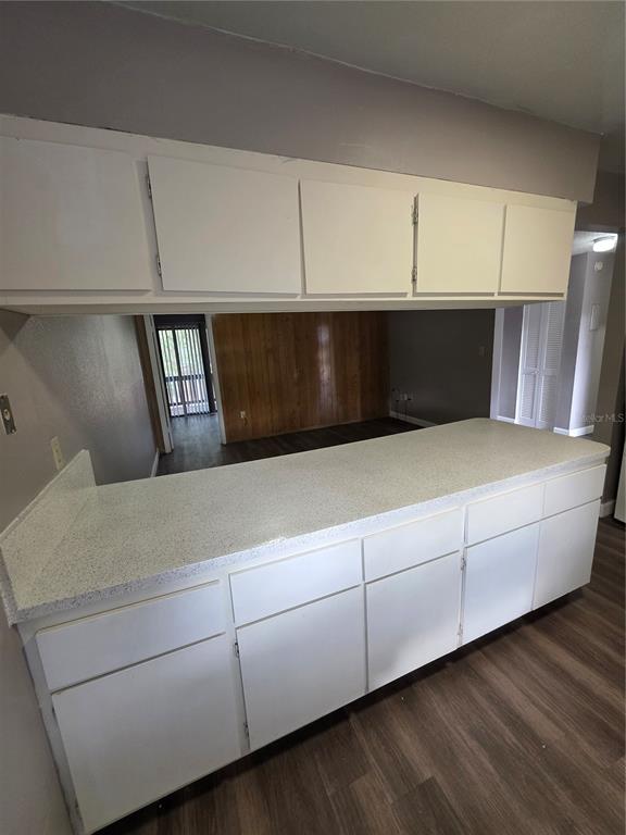 2811 Southwest Archer Road, Unit R142 Gainesville, FL 32608 - Photo 16 of 30 a living room with hard wood floors and white cabinets