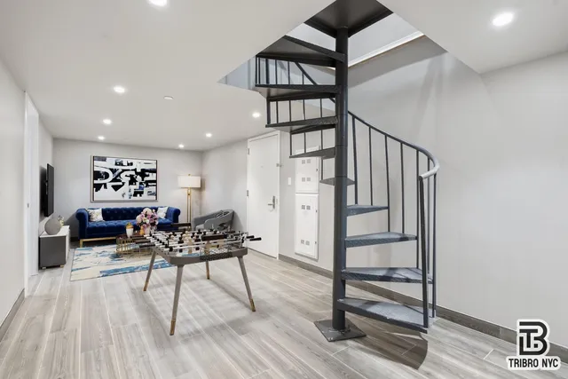 a view of a livingroom with furniture and hardwood floor