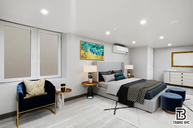 a bedroom with a bed a couch and a flat screen tv