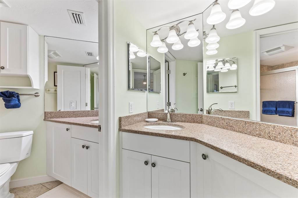 5000 Gasparilla Road, Unit BC306 Boca Grande, FL 33921 - Photo 12 of 35 a bathroom with a granite countertop sink mirror and a toilet