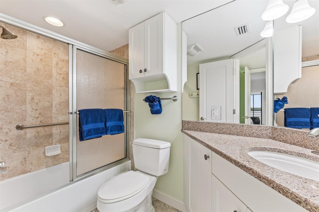5000 Gasparilla Road, Unit BC306 Boca Grande, FL 33921 - Photo 13 of 35 a bathroom with a granite countertop sink toilet and shower