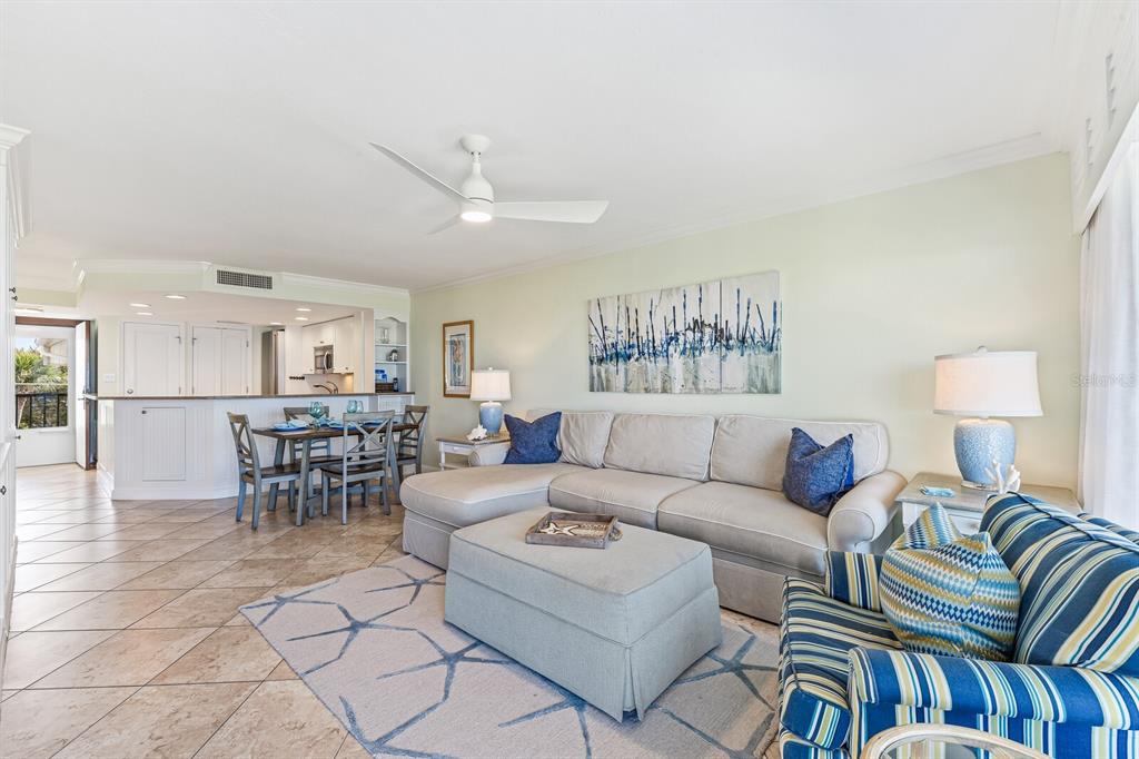 5000 Gasparilla Road, Unit BC306 Boca Grande, FL 33921 - Photo 3 of 35 a living room with furniture a table and a lamp