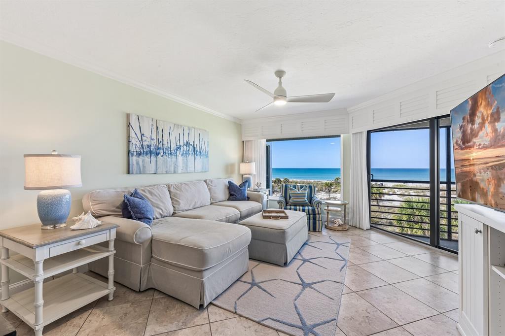 5000 Gasparilla Road, Unit BC306 Boca Grande, FL 33921 - Photo 4 of 35 a living room with furniture a rug and a chandelier