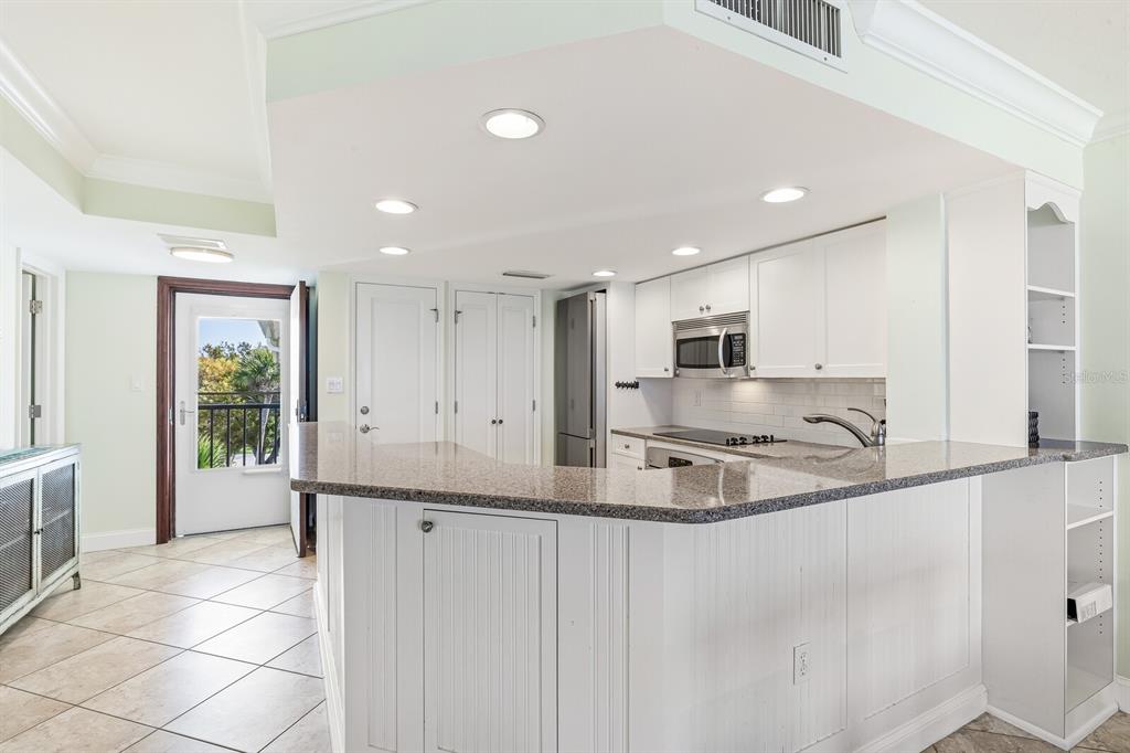 5000 Gasparilla Road, Unit BC306 Boca Grande, FL 33921 - Photo 5 of 35 a kitchen with stainless steel appliances granite countertop a sink and a refrigerator
